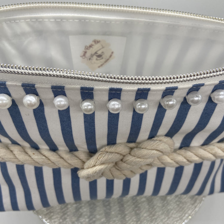 Blue and white striped nautical cosmetic bag with a figure 8 rope knot.