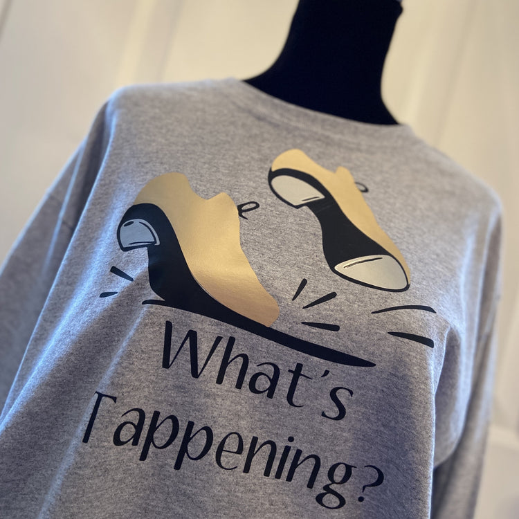 Gray t-shirt with gold tap shoes, “What’s Tappening?”.