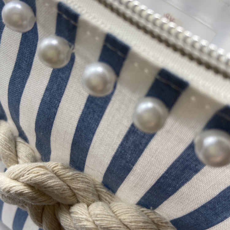 Blue and white striped nautical cosmetic bag with a figure 8 rope knot.