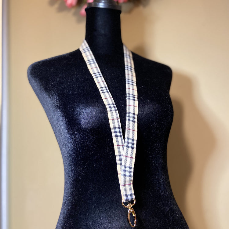 Tartan print lanyard displayed on dressform