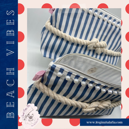 Blue and white striped nautical cosmetic bag with a figure 8 rope knot.
