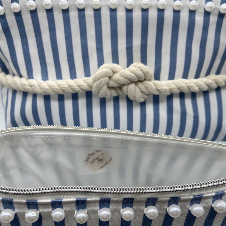 Blue and white striped nautical cosmetic bag with a figure 8 rope knot.