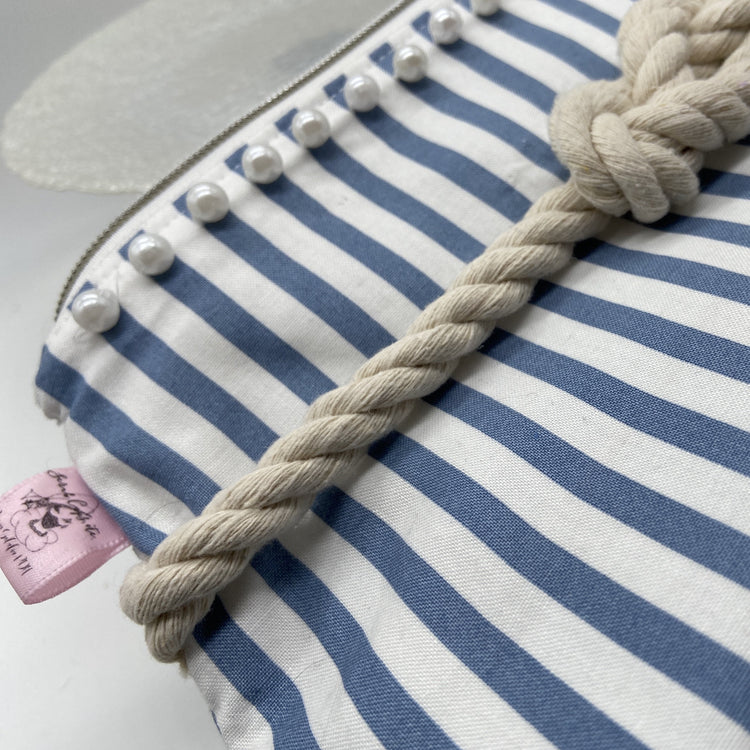 Blue and white striped nautical cosmetic bag with a figure 8 rope knot.