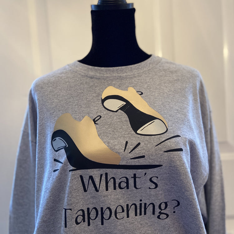 Gray t-shirt with gold tap shoes, “What’s Tappening?”.