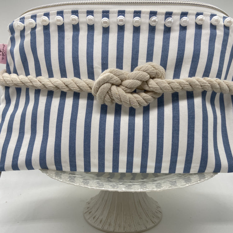 Blue and white striped nautical cosmetic bag with a figure 8 rope knot.