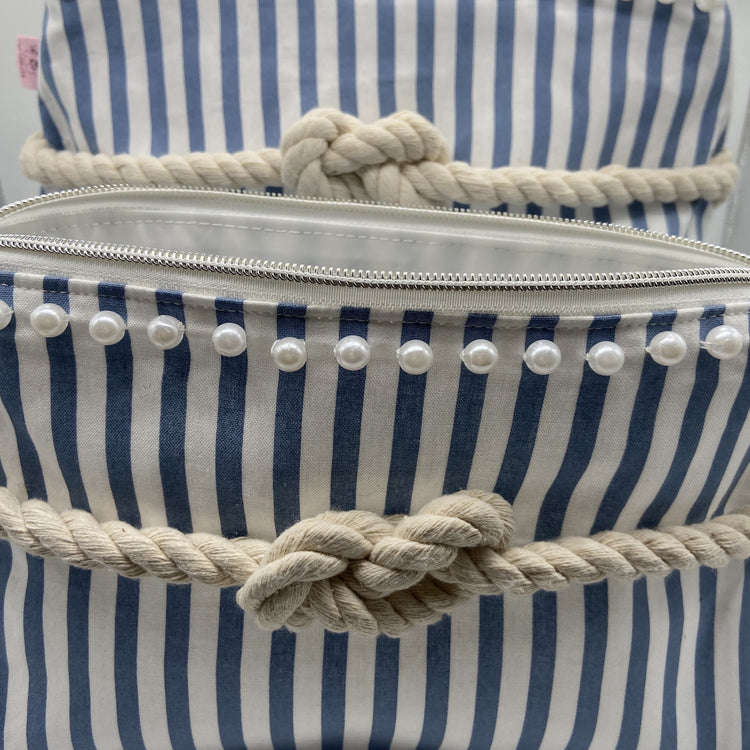 Blue and white striped nautical cosmetic bag with a figure 8 rope knot.